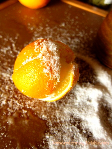Slice through each well washed lemon, stem side, leaving about 1/2 inch to keep it in tact. Be generous with that kosher salt as you pour it in the lemon.