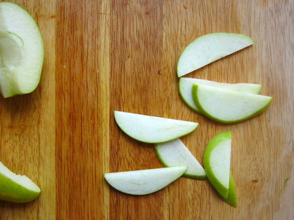 &nbsp; &nbsp; &nbsp; &nbsp; &nbsp;Using your chef knife, cut each quartered apple into slices, about 1/4 in thick.